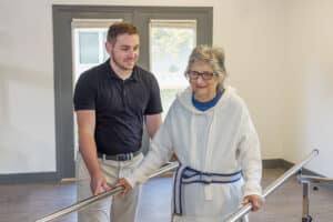 a rehab therapist and a resident at the Willow Knoll rehab gym