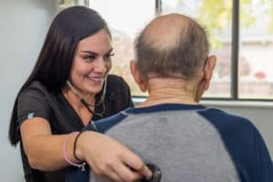 A nurse and an elderly resident at the Willow Knoll facility